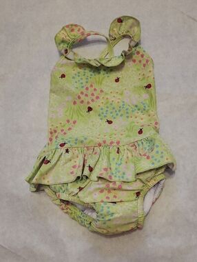 Mint green ruffled one-piece swimsuit with ladybug print